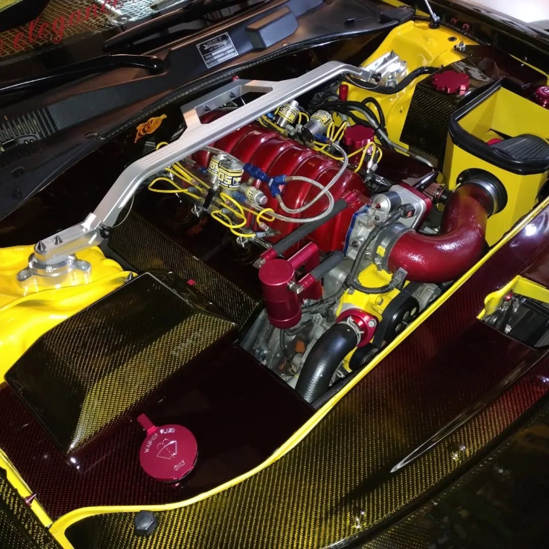 Engine bay: candy red intake, nitrous solenoids, yellow carbon panels